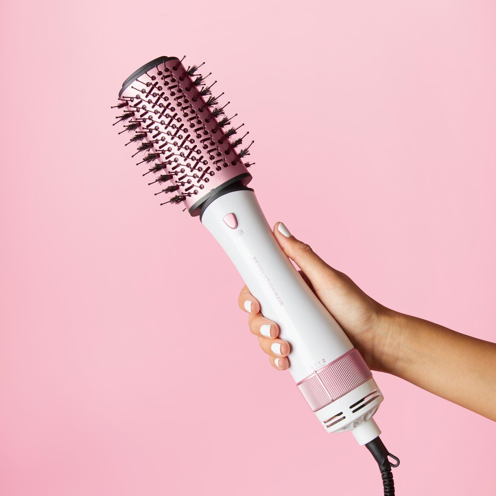 Model holding Revolution Haircare Smooth Boost Hot Air Brush
