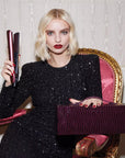 Model holding ghd Cherry Chic Gold Hair Straightener Gift Set