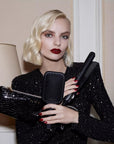 Blonde model holding ghd Gold Hair Straightener Gift Set