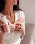 Model holding Instalash Lash & Foam Cleansing Foam with Eyelash Conditioner, and packaging