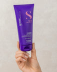 Model holding Alfaparf Milano Semi Di Lino Blonde Anti-Yellow Conditioner