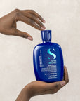 Model holding Alfaparf Milano Semi Di Lino Brunette Anti-Orange Shampoo
