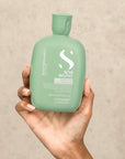 Model holding Alfaparf Milano Semi Di Lino Scalp Balancing Low Shampoo