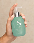 Model holding ALFAPARF MILANO Semi Di Lino Scalp Energising Tonic
