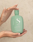 Model holding Alfaparf Milano Semi Di Lino Scalp Purifying Low Shampoo