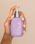 Model holding Alfaparf Milano Semi Di Lino Smooth Smoothing Cream