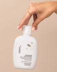 Model holding Alfaparf Milano Semi Di Lino Diamond Illuminating Low Shampoo
