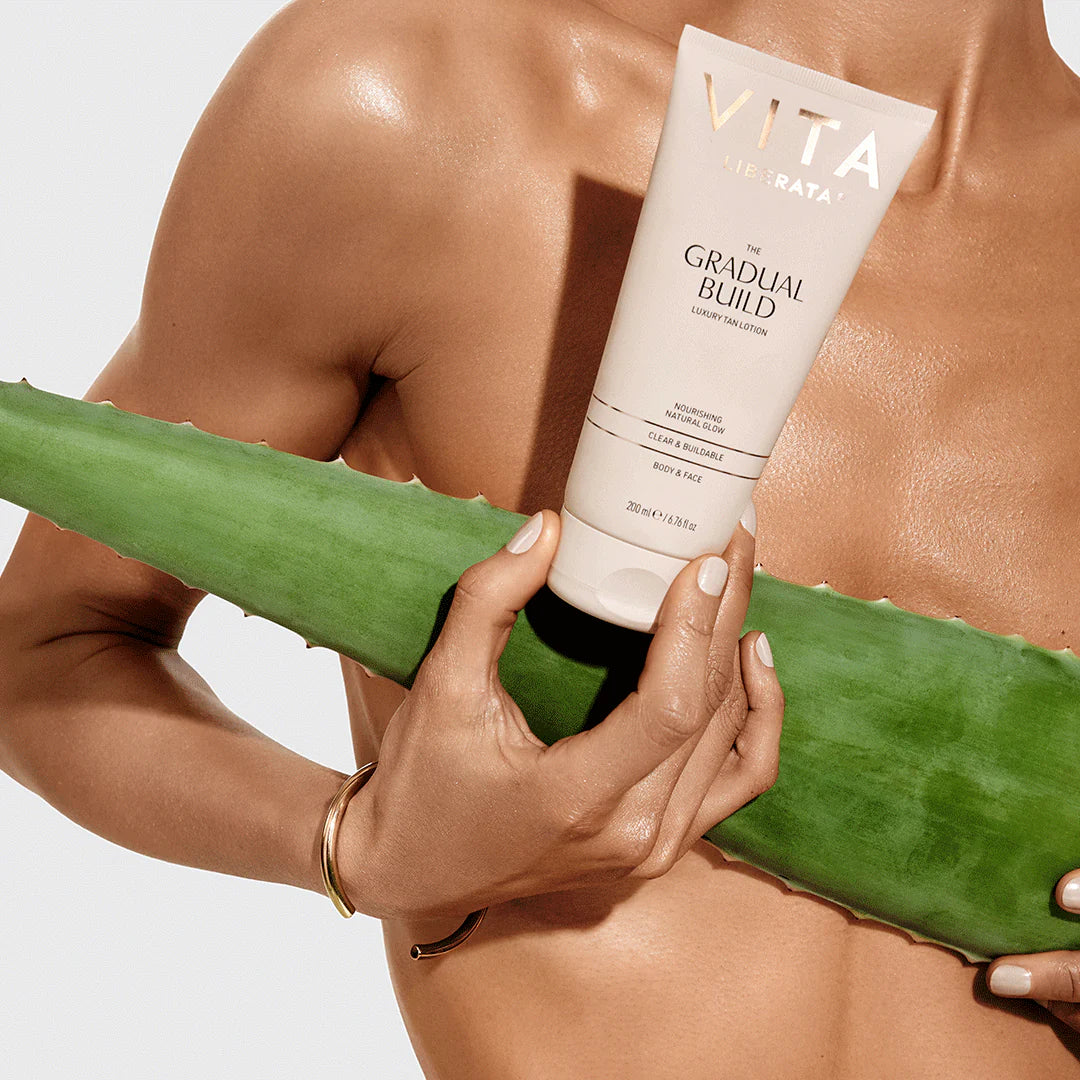 Model holding Vita Liberata Fabulous Gradual Tanning Lotion with Aloe Vera