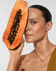 Model holding organic ingredients in Vita Liberata Fabulous Gradual Tanning Lotion formula