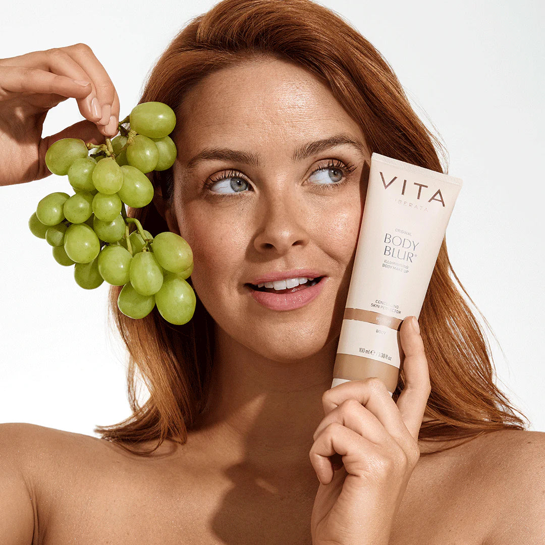 Model holding Vita Liberata Original Body Blur, with organic ingredients