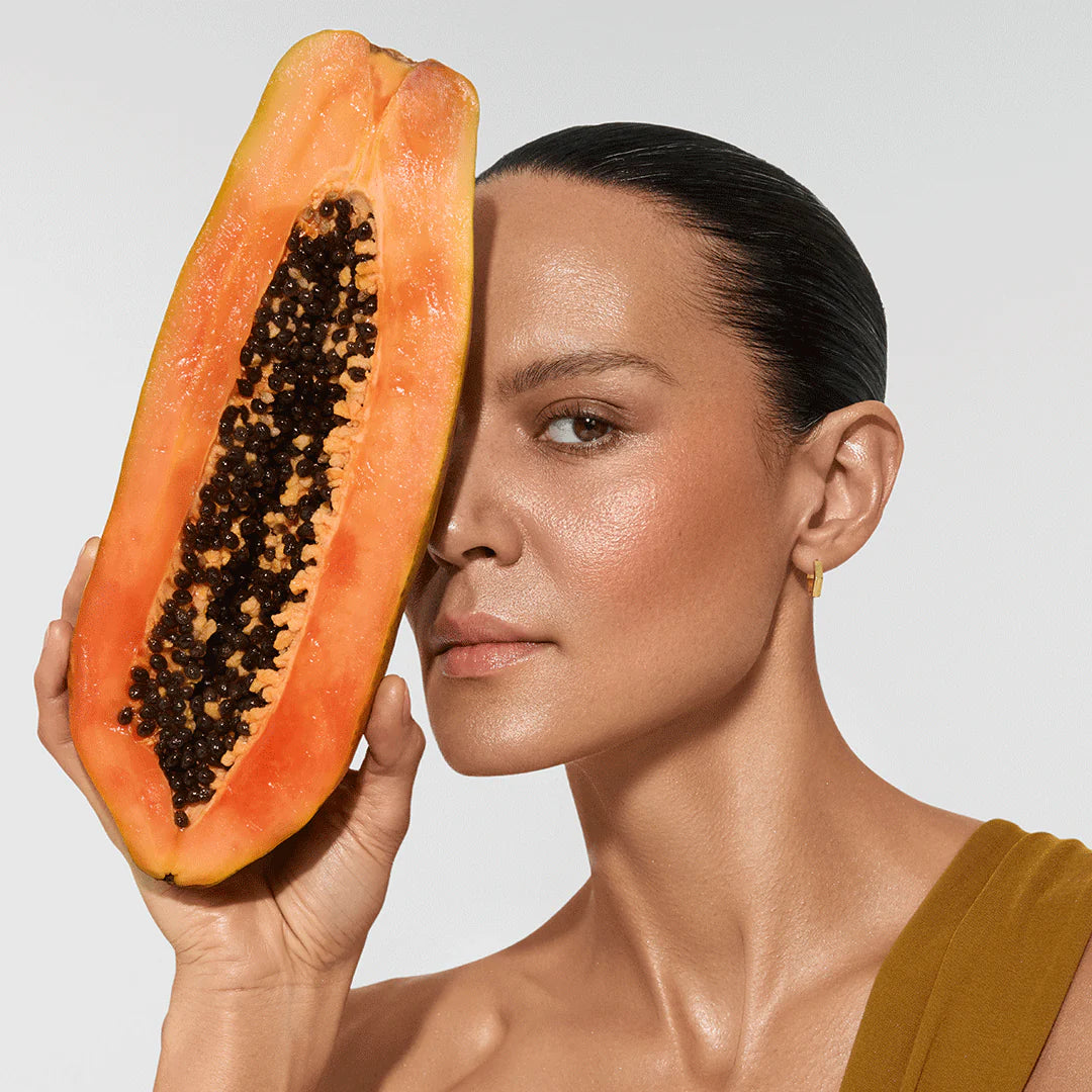 Model holding organic ingredients used in Vita Liberata The HA+ Face Tan With Niacinamide