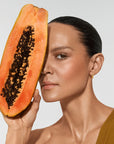 Model holding organic ingredients used in Vita Liberata The HA+ Face Tan With Niacinamide