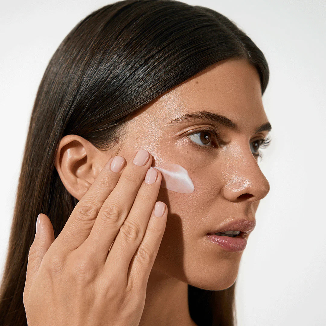 Model applying Vita Liberata The HA+ Face Tan With Niacinamide to her face
