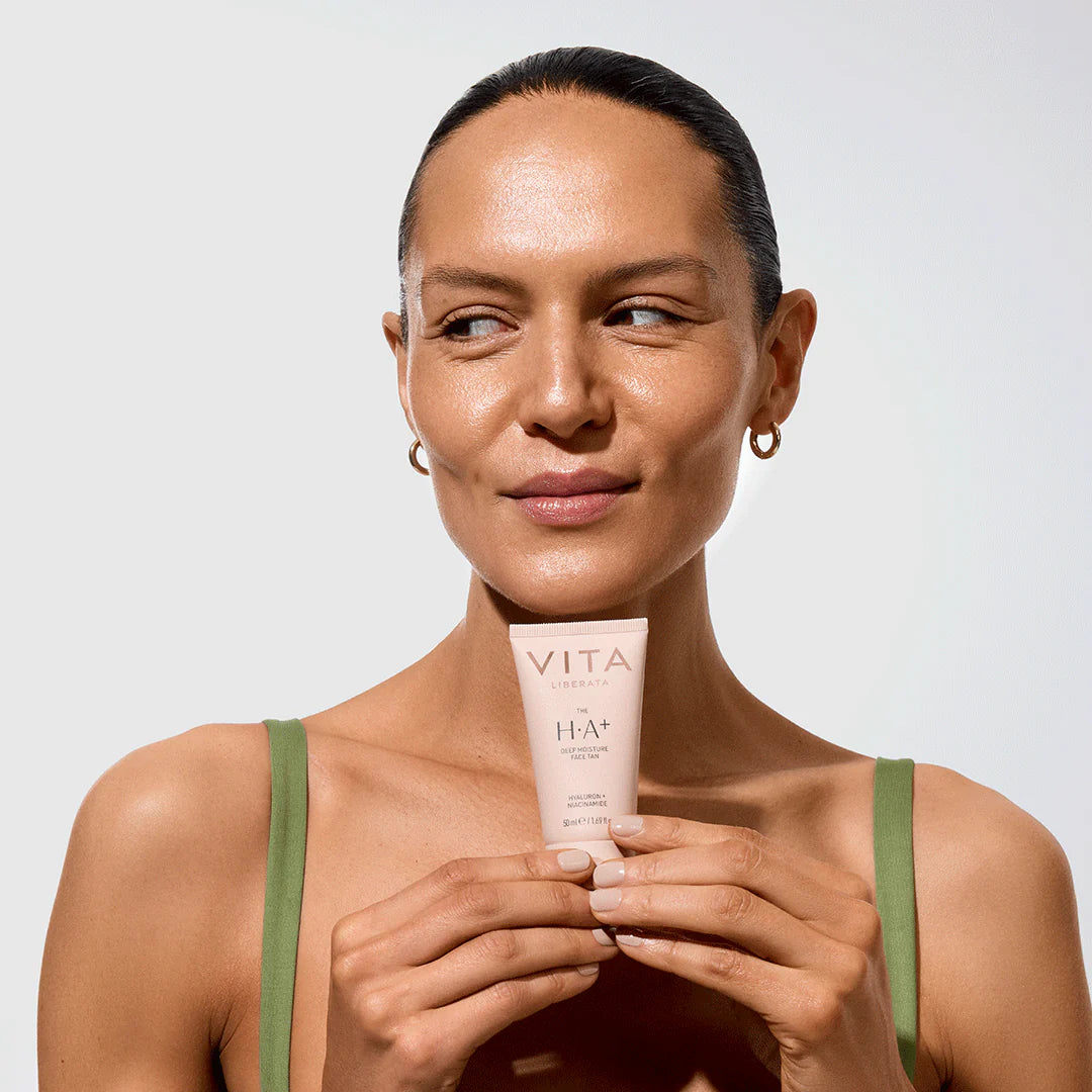 Model holding Vita Liberata The HA+ Face Tan With Niacinamide