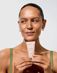 Model holding Vita Liberata The HA+ Face Tan With Niacinamide