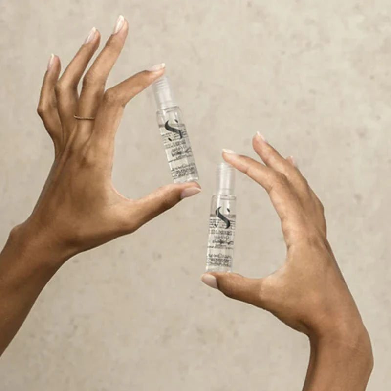 Model holding Alfaparf Milano Semi Di Lino Scalp Renew Energising Lotion