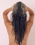 Model using Hairburst Shampoo & Conditioner For Longer Stronger Hair