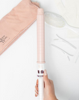 Model holding Beauty Works X Molly Mae Curl Kit