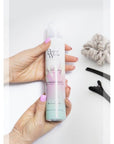Model holding Beauty Works Dry Oil Spray