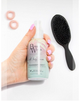 Model holding Beauty Works Anti Frizz Serum