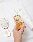 Model holding Beauty Works Argan Serum 90ml