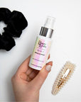 Model holding BEAUTY WORKS 10-in-1 Miracle Spray