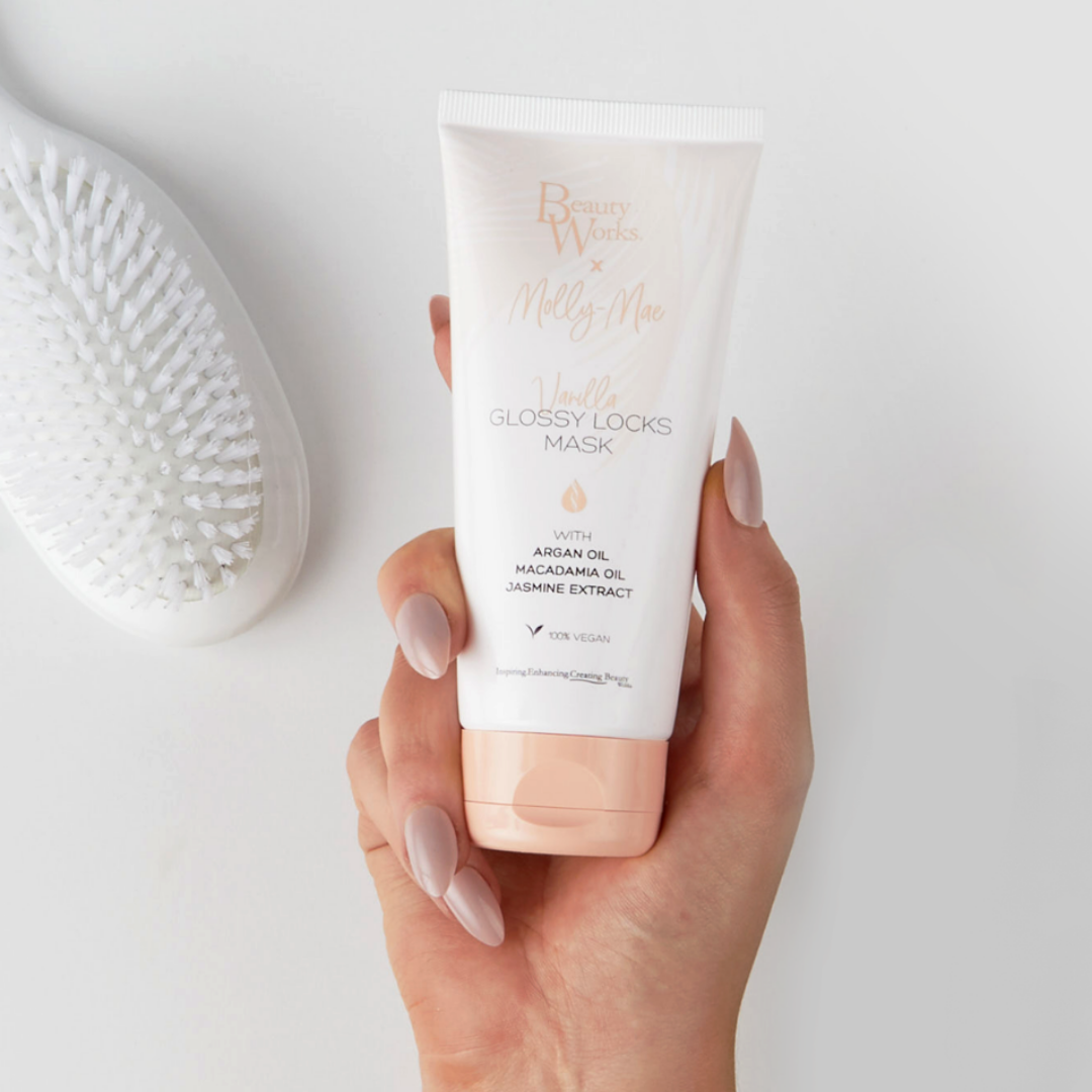 Model holding BEAUTY WORKS X MOLLY-MAE VANILLA GLOSS LOCKS MASK 100ml