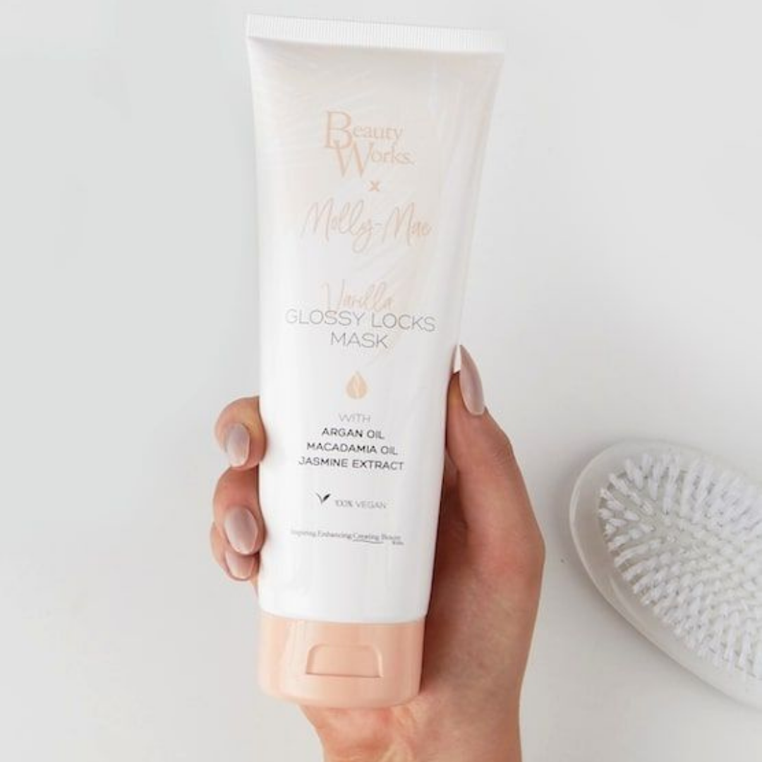 Model holding BEAUTY WORKS X MOLLY-MAE VANILLA GLOSS LOCKS MASK 250ml