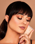 Model wearing INGLOT Rosie For Inglot Illuminating & Brightening Face Base - Honey Glow