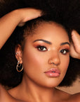Model wearing INGLOT Rosie For Inglot Illuminating & Brightening Face Base - Latte Glow
