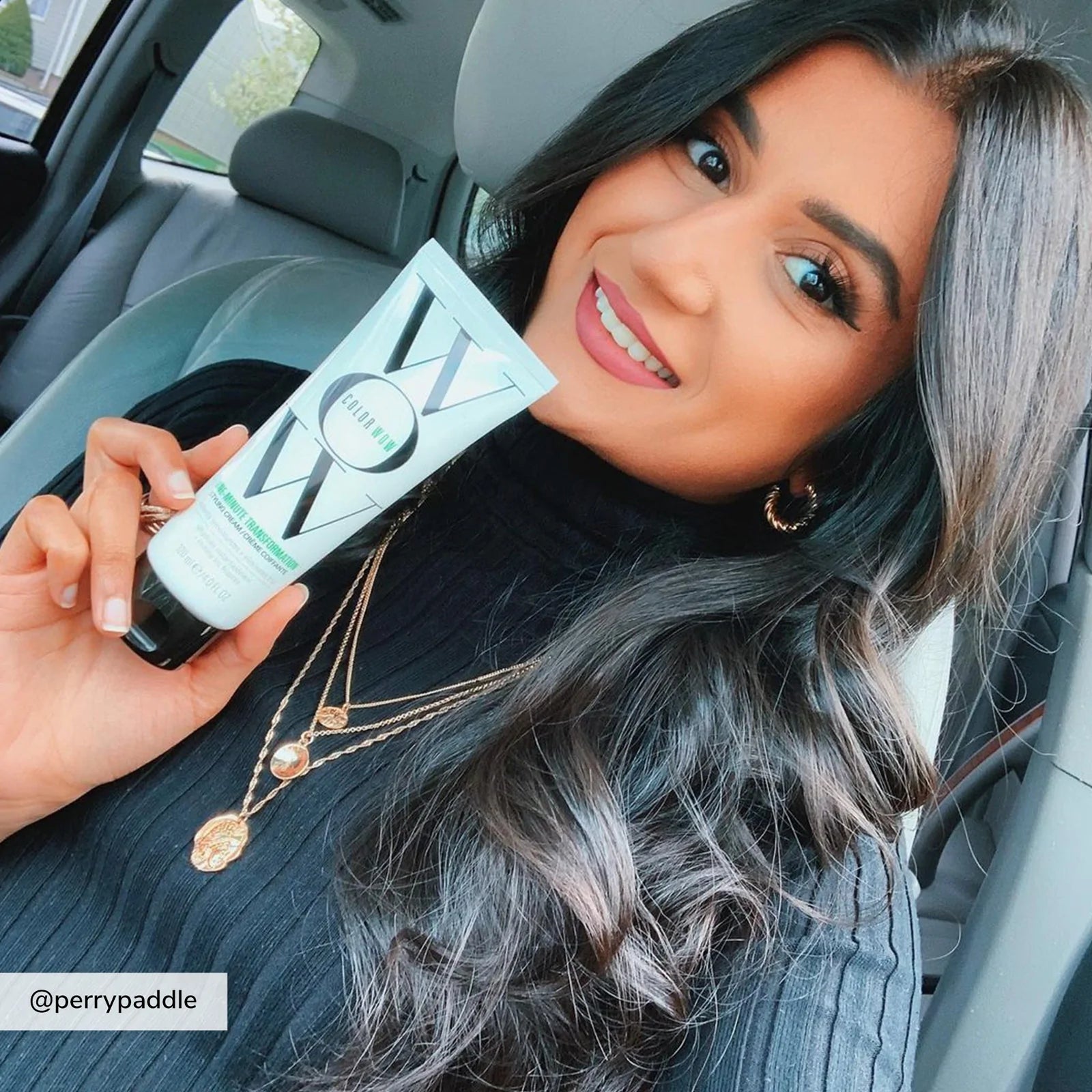 Model holding Color Wow One-Minute Transformation Styling Cream