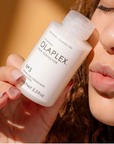 Model holding OLAPLEX No.3 Hair Perfector