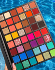 Model holding LaRoc PRO The Artistry Palette by the pool