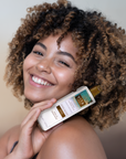 Model holding Vita Liberata Untinted Heavenly Tanning Elixir - Medium