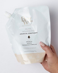 Model holding Beauty Works Pearl Nourishing Conditioner Refill Pouch 500ml
