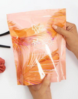 Model holding Beauty Works After Sun Anti-Colour Fade Duo