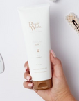 Model holding Beauty Works Restore Mask