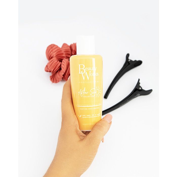 Model holding Beauty Works After Sun Conditioner Treatment 150ml