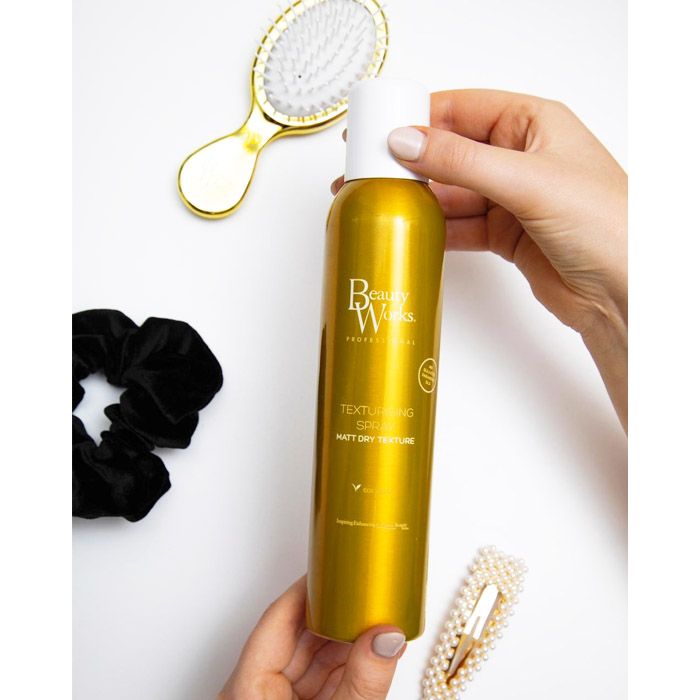 Model holding Beauty Works Texturising Spray 250ml