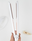 Model holding BEAUTY WORKS X MOLLY-MAE HAIR STRAIGHTENER