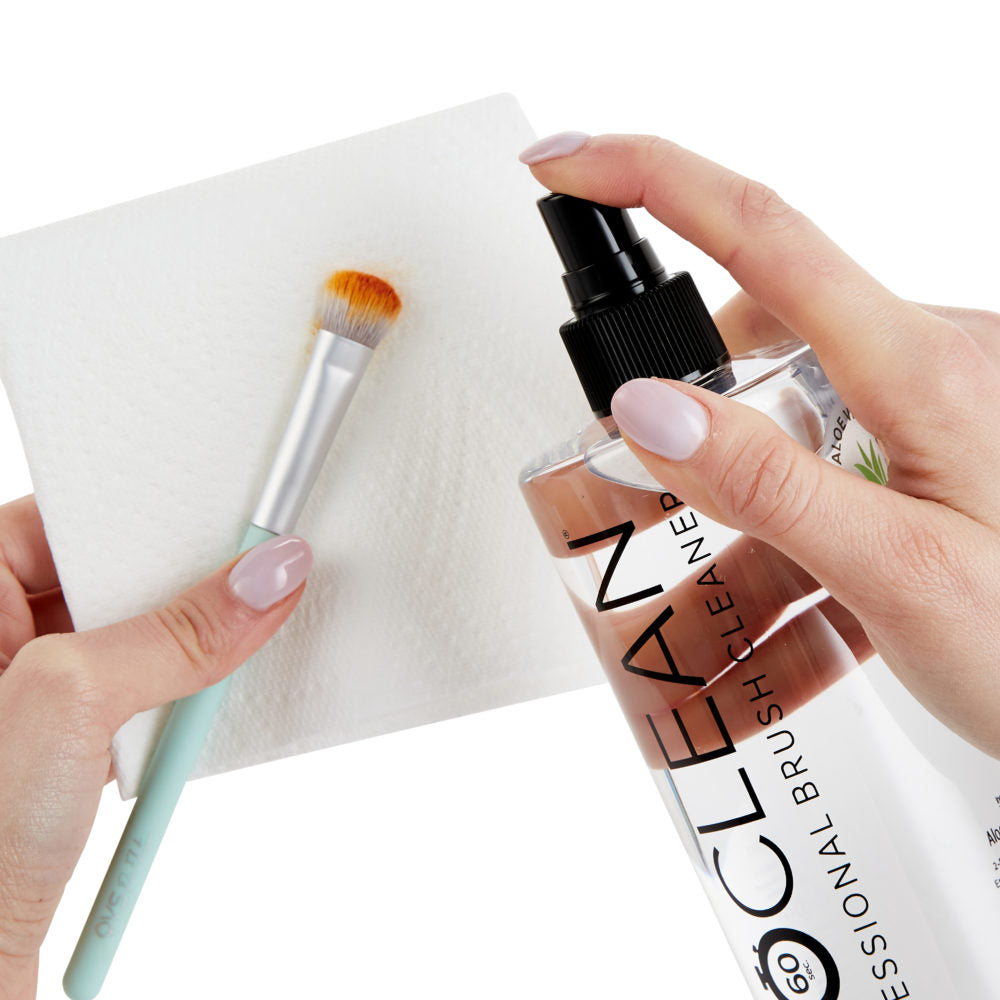 Using ISOCLEAN Makeup Brush Cleaner With Spray Top with tissue