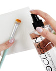 Using ISOCLEAN Makeup Brush Cleaner With Spray Top with tissue