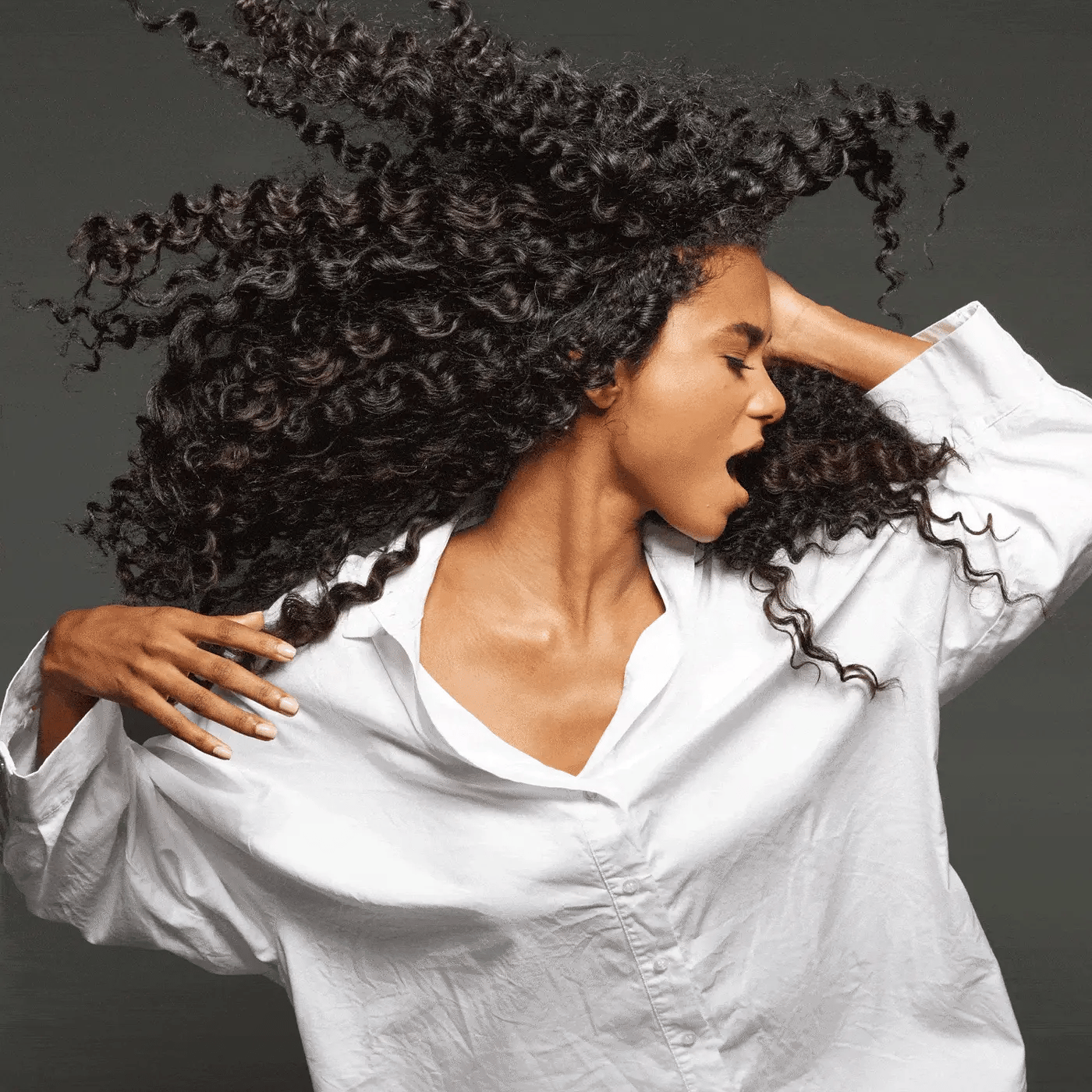 Model with hair styled using Color Wow Hooked 100% Clean Shampoo with Root-Locking Technology