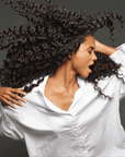 Model with hair styled using Color Wow Flo-etry Vital Natural Serum