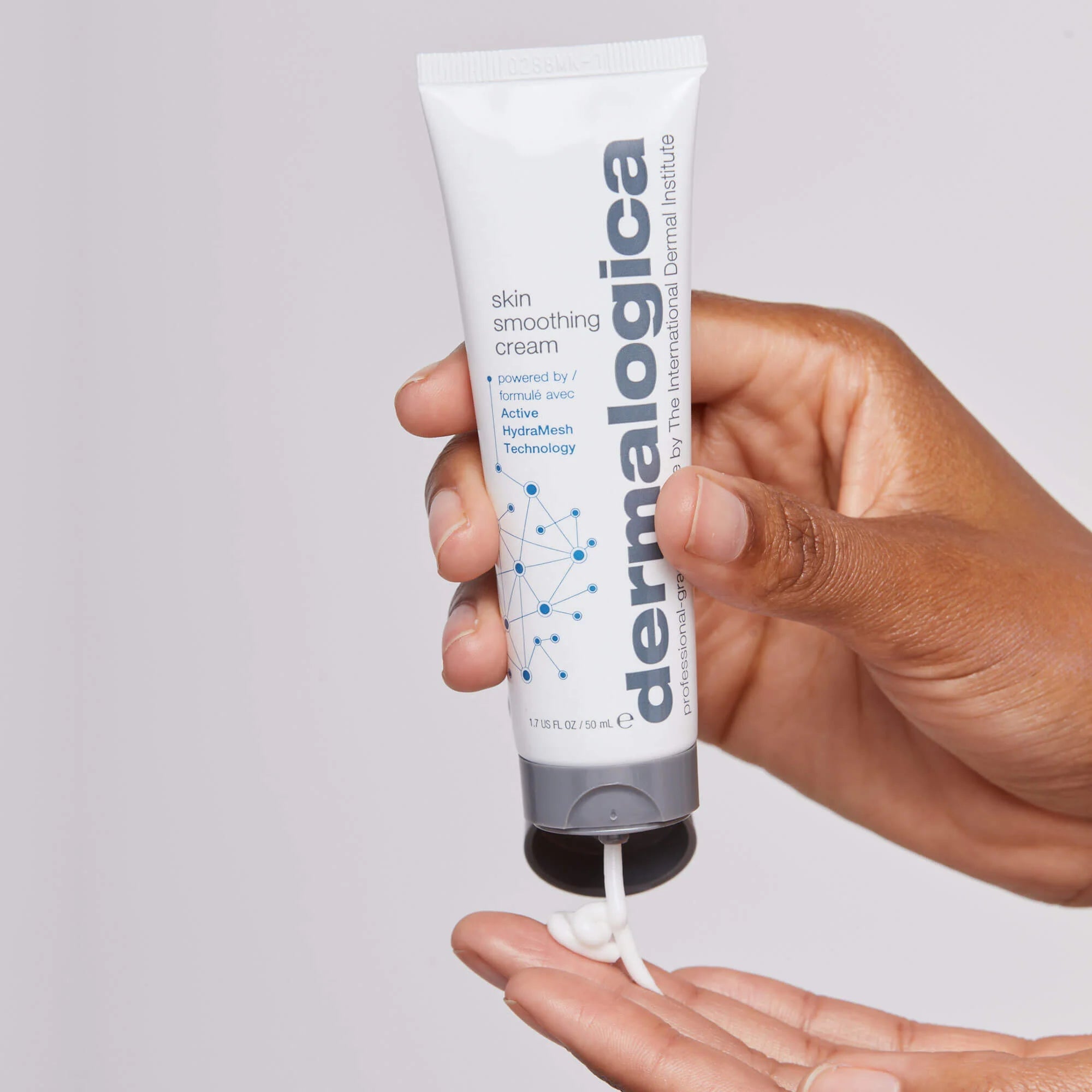 Model holding Dermalogica Skin Smoothing Cream Moisturiser