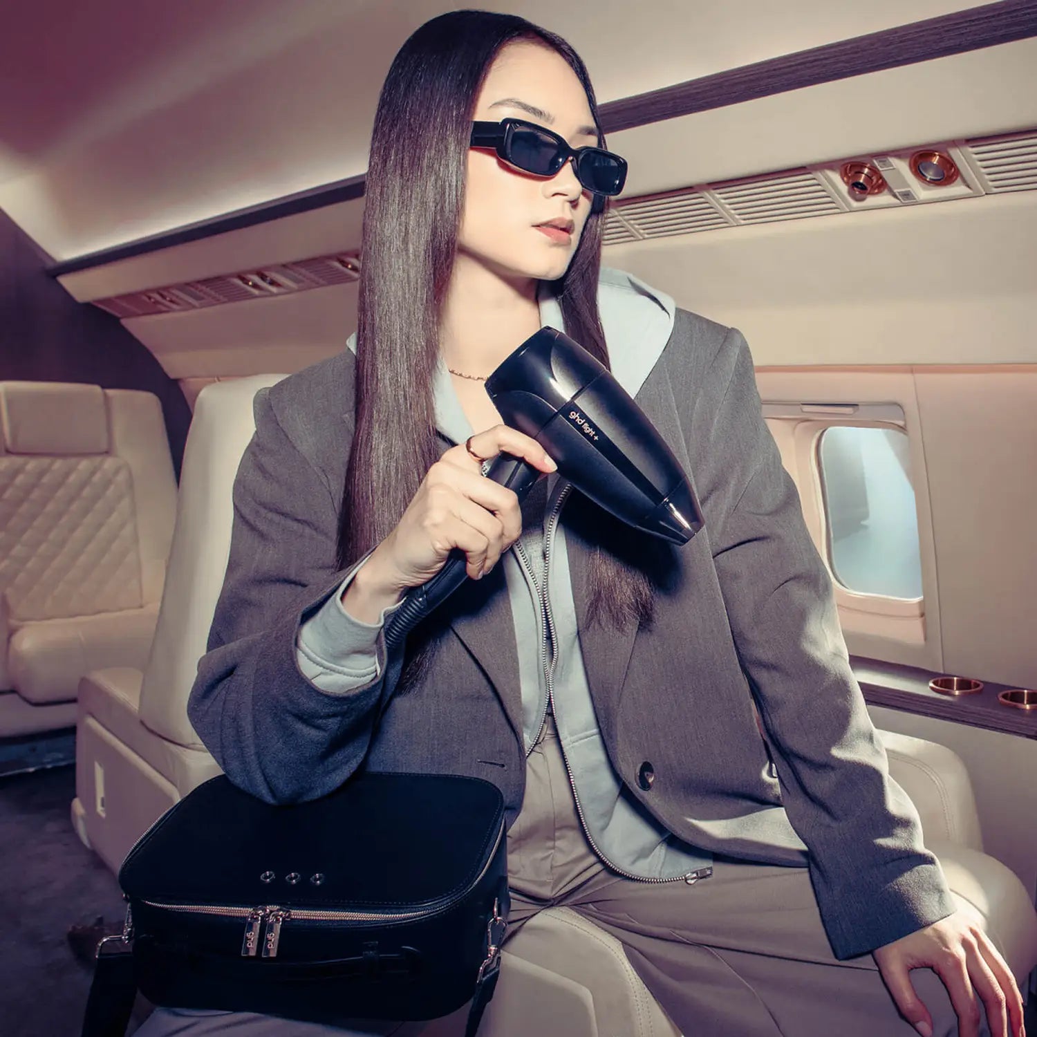 Model traveling with ghd Flight+ Travel Hair Dryer 