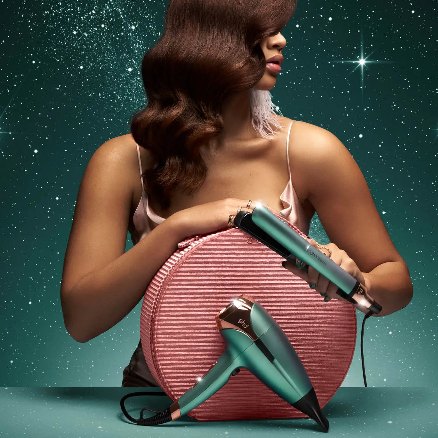Model holding ghd Deluxe Gift Set In Alluring Jade