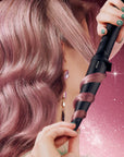 Model styling hair using ghd Curve Creative Curl Wand Christmas Gift Set
