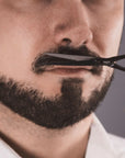 Model using Parsa Beauty Beard Grooming Set to trim beard