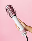 Model holding Revolution Haircare Smooth Boost Hot Air Brush